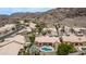 An aerial view shows the neighborhood homes and a mountain in the background on a sunny day at 14033 S 31St St, Phoenix, AZ 85048