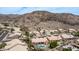 An aerial view shows the neighborhood homes and a mountain in the background on a sunny day at 14033 S 31St St, Phoenix, AZ 85048