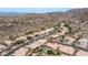 An aerial view shows the neighborhood homes and a mountain in the background on a sunny day at 14033 S 31St St, Phoenix, AZ 85048