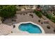 An aerial shot displays a private backyard with a pool, desert landscaping, and multiple lounge areas at 14033 S 31St St, Phoenix, AZ 85048