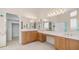 Bathroom with a large vanity, dual sinks, and a linen closet at 14033 S 31St St, Phoenix, AZ 85048