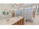 Bathroom featuring double sinks, a large mirror, and a shower-tub combination at 14033 S 31St St, Phoenix, AZ 85048