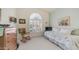 Bright bedroom with a daybed, rocking chair, and arched window with shutters at 14033 S 31St St, Phoenix, AZ 85048