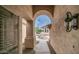Charming home exterior with stucco facade, arched entry, and desert landscaping leading to the front door at 14033 S 31St St, Phoenix, AZ 85048