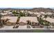 An aerial view shows the homes' exterior with a three car garage, desert landscaping and tile roof at 14033 S 31St St, Phoenix, AZ 85048