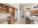 Bright kitchen with wood cabinets, double ovens, desk area, and tile flooring at 14033 S 31St St, Phoenix, AZ 85048
