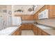 Bright kitchen featuring wood cabinets, island, and a view of the cooktop at 14033 S 31St St, Phoenix, AZ 85048