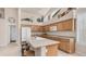 Kitchen with an island, seating, wood cabinets, and clerestory windows at 14033 S 31St St, Phoenix, AZ 85048