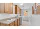Well-equipped laundry room with cabinetry, sink, and modern washer and dryer at 14033 S 31St St, Phoenix, AZ 85048