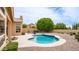 A picturesque backyard boasts a freeform pool, mature trees, and a cozy patio area for relaxation at 14033 S 31St St, Phoenix, AZ 85048