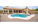 The backyard shows the refreshing pool surrounded by gravel, a covered patio, and desert landscaping at 14033 S 31St St, Phoenix, AZ 85048