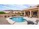 Serene backyard oasis with a sparkling pool, desert landscaping, and comfortable patio seating at 14033 S 31St St, Phoenix, AZ 85048