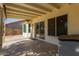 Covered back patio with sliding glass doors that lead to a bright sunroom at 150 N Nielson St, Gilbert, AZ 85234