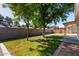 Large backyard with mature trees and a covered patio, ideal for outdoor living at 150 N Nielson St, Gilbert, AZ 85234