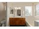 Bright bathroom featuring a double vanity, large mirror, and a soaking tub at 150 N Nielson St, Gilbert, AZ 85234
