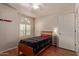 Cozy bedroom featuring wood floors and a well-lit window with light-filtering shutters at 150 N Nielson St, Gilbert, AZ 85234