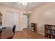 Home office/bedroom with hardwood-style floors, a closet, and a view into the hallway at 150 N Nielson St, Gilbert, AZ 85234