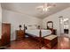 Cozy bedroom featuring wood floors, a ceiling fan, and furniture at 150 N Nielson St, Gilbert, AZ 85234