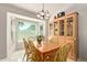 Bright dining room with bay window, tile flooring, and a classic china cabinet at 150 N Nielson St, Gilbert, AZ 85234