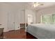 Spacious main bedroom with hardwood floors, a ceiling fan, and an ensuite bathroom at 150 N Nielson St, Gilbert, AZ 85234