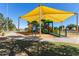 Community playground area with colorful play structures and sun protection for outdoor fun at 150 N Nielson St, Gilbert, AZ 85234