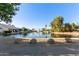 Water view of pond with fountain and surrounding neighborhood residences at 150 N Nielson St, Gilbert, AZ 85234