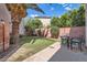 Private backyard features a grassy area, shade trees, and patio with seating at 15550 N Frank Lloyd Wright Blvd # 1101, Scottsdale, AZ 85260