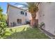 The backyard features a grassy area, a patio set with a table and chairs, and a grill at 15550 N Frank Lloyd Wright Blvd # 1101, Scottsdale, AZ 85260