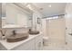 Bright bathroom with double sinks, modern fixtures, and a shower-tub combo at 15550 N Frank Lloyd Wright Blvd # 1101, Scottsdale, AZ 85260