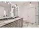 Elegant bathroom features a double vanity with granite countertop, modern lighting and marble floors at 15550 N Frank Lloyd Wright Blvd # 1101, Scottsdale, AZ 85260