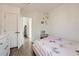 Bright bedroom features a pink bed frame, hardwood floors and an open doorway at 15550 N Frank Lloyd Wright Blvd # 1101, Scottsdale, AZ 85260
