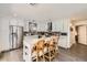Modern kitchen with white cabinetry, island seating, and stainless steel appliances at 15550 N Frank Lloyd Wright Blvd # 1101, Scottsdale, AZ 85260