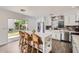 Modern kitchen with white cabinetry, island seating, and stainless steel appliances at 15550 N Frank Lloyd Wright Blvd # 1101, Scottsdale, AZ 85260