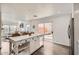 Bright open-concept kitchen featuring a white island with marble countertop and access to the patio at 15550 N Frank Lloyd Wright Blvd # 1101, Scottsdale, AZ 85260