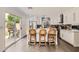Contemporary kitchen with a central island, stainless steel appliances, and access to the backyard at 15550 N Frank Lloyd Wright Blvd # 1101, Scottsdale, AZ 85260