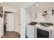 Convenient laundry room with modern washer and dryer and built-in shelving at 15550 N Frank Lloyd Wright Blvd # 1101, Scottsdale, AZ 85260