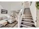 Bright living room with tall ceilings, hardwood floors, and decorative staircase at 15550 N Frank Lloyd Wright Blvd # 1101, Scottsdale, AZ 85260