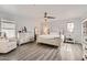 Spacious main bedroom featuring hardwood floors, a ceiling fan, and ample natural light at 15550 N Frank Lloyd Wright Blvd # 1101, Scottsdale, AZ 85260