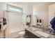 Bright bathroom showcasing granite counters, a stylish mirror, and a tub-shower combo at 15791 W Kendall St, Goodyear, AZ 85338