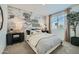 Inviting bedroom featuring a cozy bed, stylish lighting, and a cloud themed accent wall at 15791 W Kendall St, Goodyear, AZ 85338