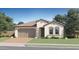 Charming single-story home showcasing a neutral color palette, tiled roof, and a two-car garage at 15791 W Kendall St, Goodyear, AZ 85338