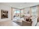Inviting living room with neutral furniture, ample natural light, and an open view to the backyard at 15791 W Kendall St, Goodyear, AZ 85338