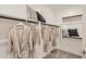 Walk-in closet features custom shelving, hanging rods, and ample space for clothing and accessories at 15791 W Kendall St, Goodyear, AZ 85338