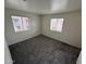 Clean, carpeted bedroom with natural light from two windows offering views of the surroundings at 16602 N 25Th St # 217, Phoenix, AZ 85032