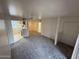 Spacious living room featuring new carpeting, a ceiling fan, and easy access to the kitchen at 16602 N 25Th St # 217, Phoenix, AZ 85032