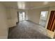 Bright living space featuring contemporary carpeting and seamless access to the outdoor patio at 16602 N 25Th St # 217, Phoenix, AZ 85032