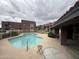 Community pool with surrounding buildings, fence, and covered area at 16602 N 25Th St # 217, Phoenix, AZ 85032