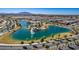 Stunning aerial view of a community lake with a fountain and waterside park at 18883 E Celtic Manor Dr, Queen Creek, AZ 85142