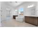 Bright primary bathroom with dual vanities, soaking tub and large windows offering plenty of natural light at 18883 E Celtic Manor Dr, Queen Creek, AZ 85142