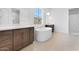 Modern bathroom featuring dual vanities, a soaking tub under a window, and a separate walk-in shower at 18883 E Celtic Manor Dr, Queen Creek, AZ 85142